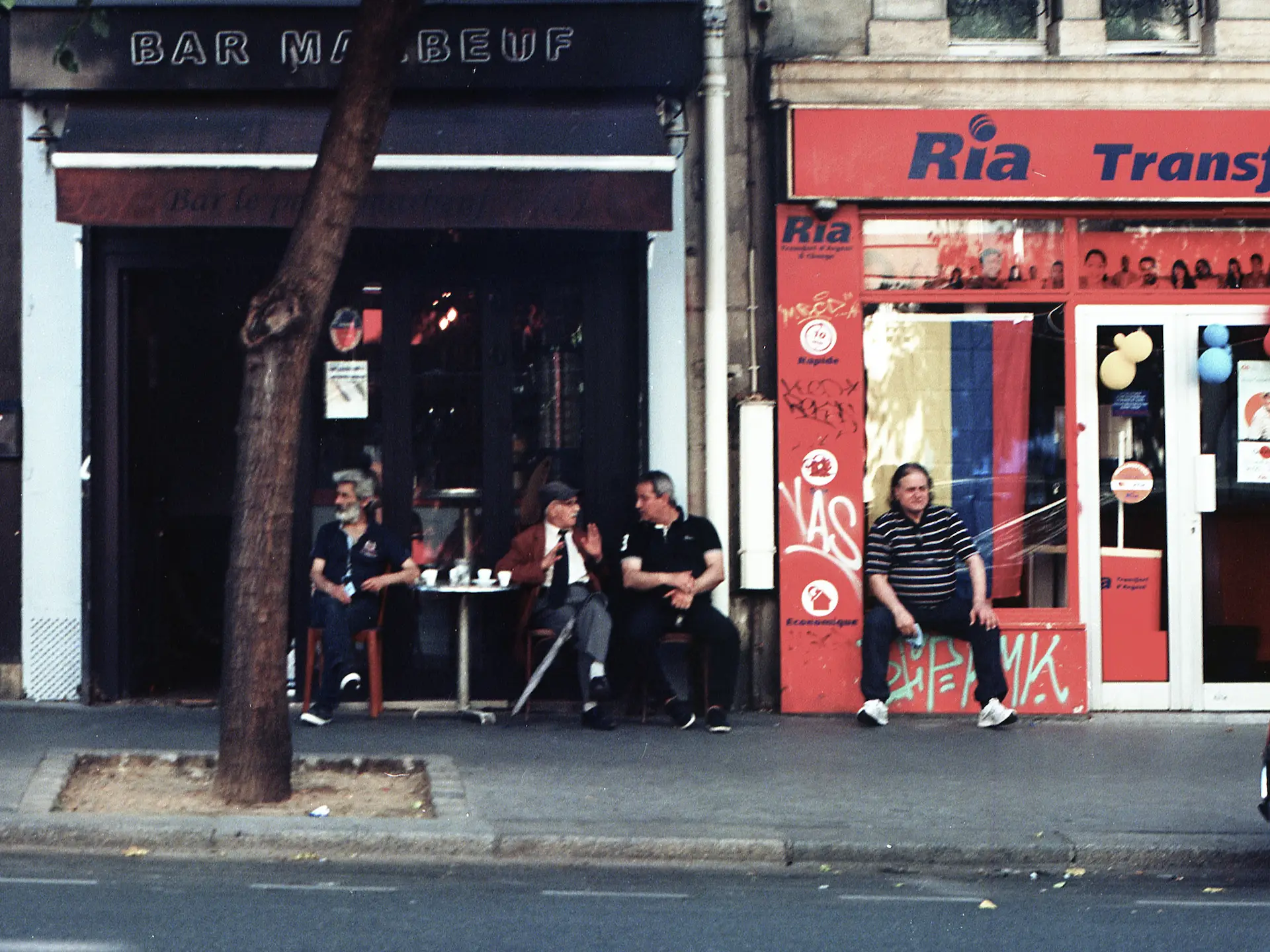 Men talking outside of café, Paris